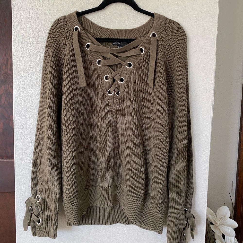 Women’s plus size Forever 21 sweater with grommet and lacing detail.
